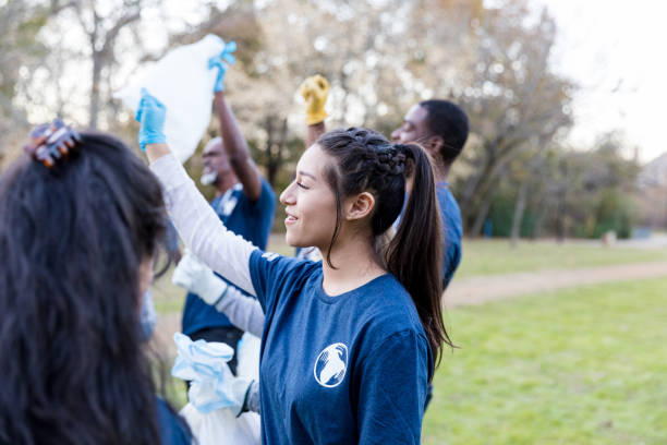 istock Diverse park cleanup volunteers raise gloved hands 1195063309