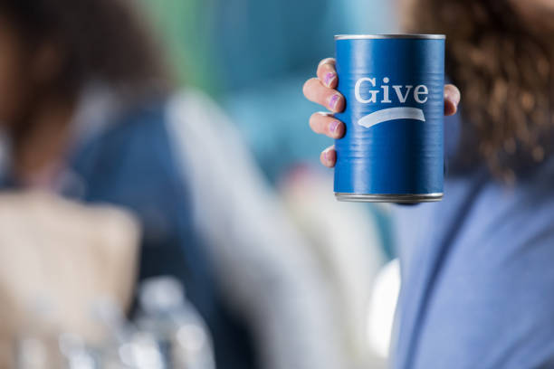Volunteer holds donation can during food drive