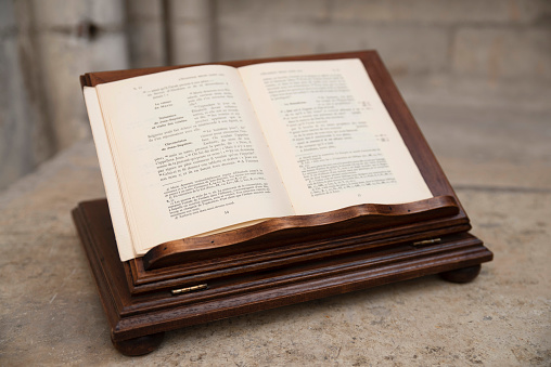 Ancient religious book open on a wooden lectern