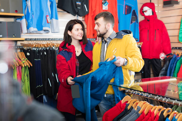 istock Couple choosing jacket in store 1195066753