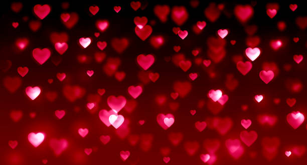 istock Red hearts on black background, gradient, bright, glow, glitter, holiday, wedding, romance, Valentine's day, love, many hearts, bokeh background 1195067774