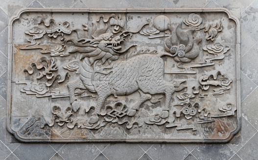 Stone Kylin (Qilin) statue in chenghuang temple shanghai, China. A mythical hooved chimerical creature known in Chinese and other East Asian cultures