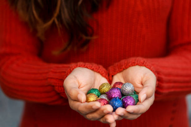 istock Female Hands Holding Christmas Balls Background 1195074726