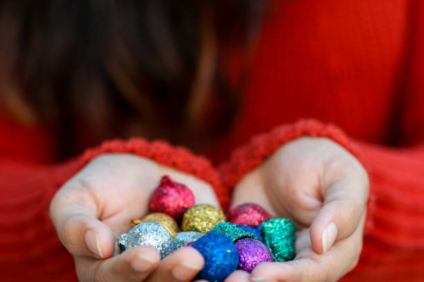 istock Hands Holding Decorative Christmas Balls Background 1195074889