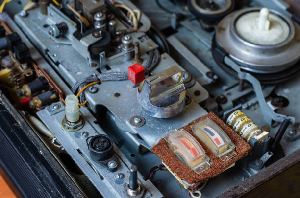 istock Side view of a vintage disassembled bobbin tape recorder. 1195077909