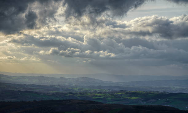 istock Cloudy landscape over the  farms and meadows 1195078483