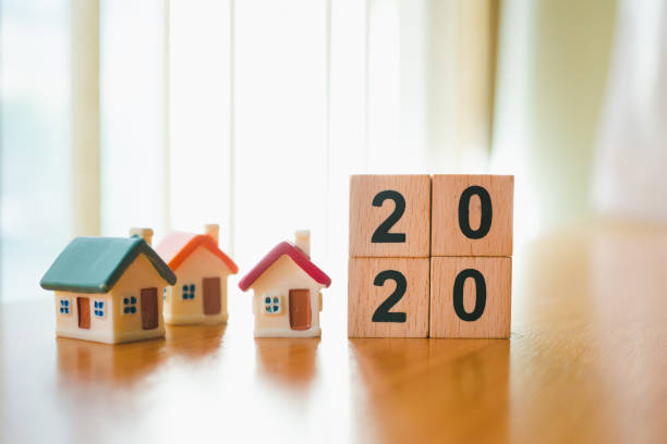 istock Wooden block year 2020 with mini house 1195079474