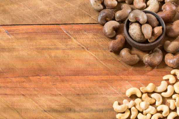 Cashew nut on wooden background - Anacardium occidentale