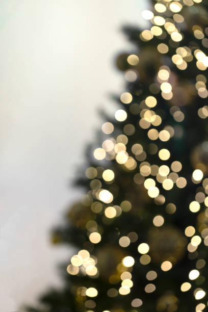 istock Vertical view of blurred christmas tree with garlands. 1195079956