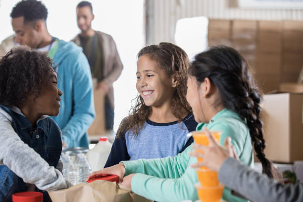 istock Happy children volunteering together 1195081092
