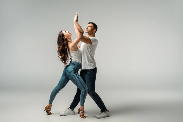 istock dancers looking up and dancing bachata on grey background 1195081195