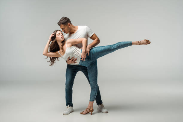 istock dancers in denim jeans dancing bachata on grey background 1195081201