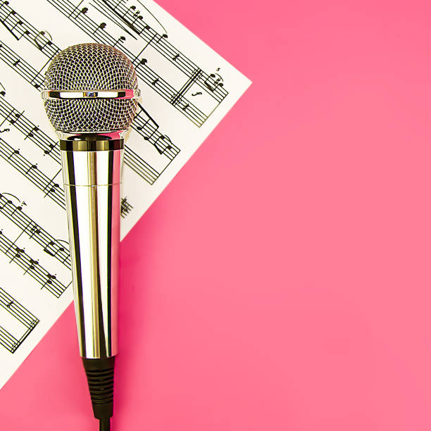 Close-up of microphone placed on sleek piano keys, capturing sound and creativity. microphone is perfectly positioned to highlight piano's rich tones.