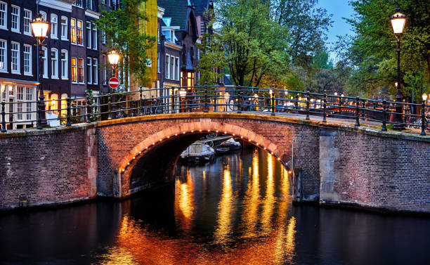 istock Amsterdam, Netherlands. Bridges with nighttime illumination 1195082469