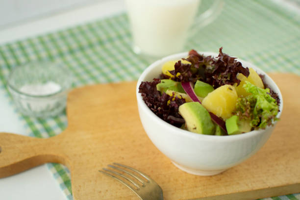 Dietary salad of potatoes, avocado and red onion.