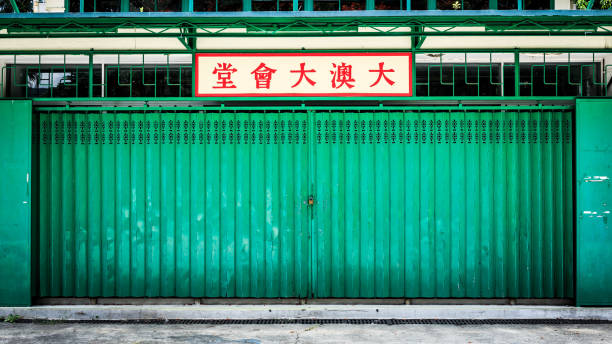 green weathered metallic roll up door. Rusty iron gate