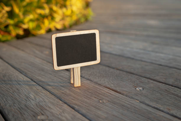 istock Blank wooden blackboard labelon wooden background 1195084842