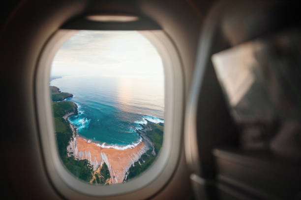 Tropical island at Maldives in airplane window - travel background