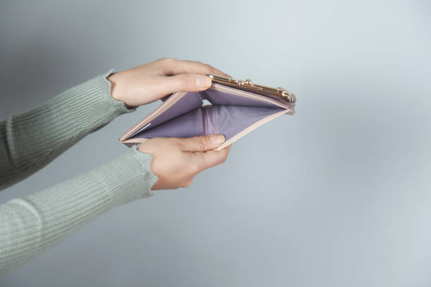 istock woman hand holding empty wallet 1195085962