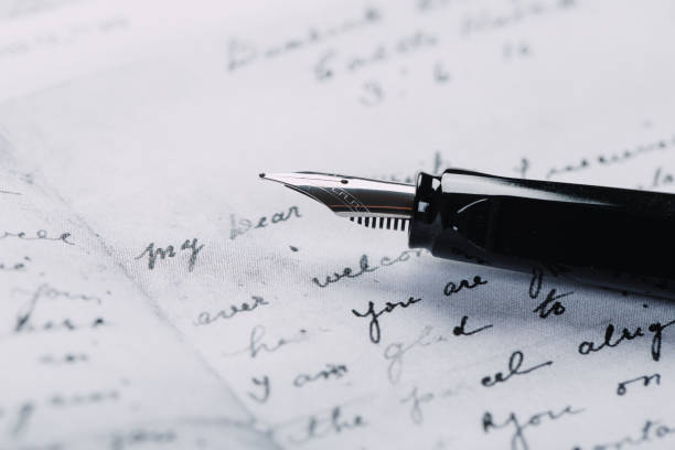 istock fountain pen on paper with ink text closeup 1195086210