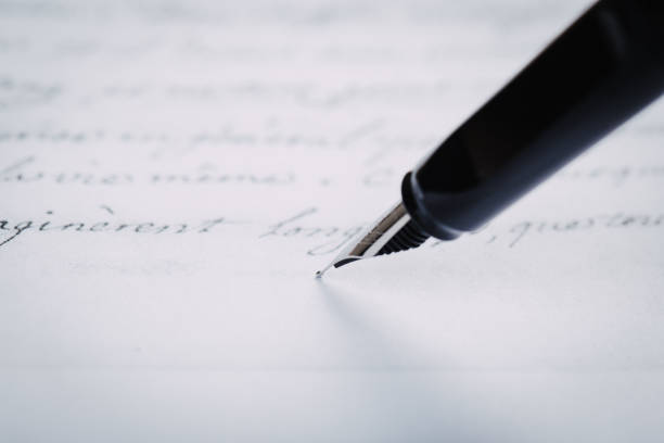 istock fountain pen on paper with ink text closeup 1195086216