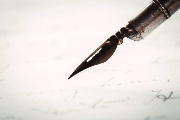 istock fountain pen on paper with ink text closeup 1195086218
