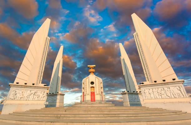 demokratiedenkmal im zentrum von bangkok, thailand, sonnenaufgang mit wolken, lichtstrahlen und anderen atmosphärischen effekten - indigenous culture famous place thailand bangkok stock-fotos und bilder