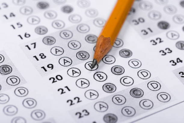 istock testing in exercise and exam paper. computer sheet with pencil in school test room, education concept 1195086274