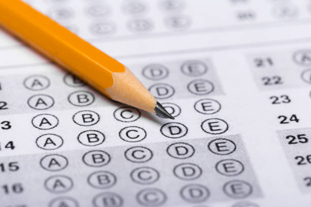 istock testing in exercise and exam paper. computer sheet with pencil in school test room, education concept 1195086328