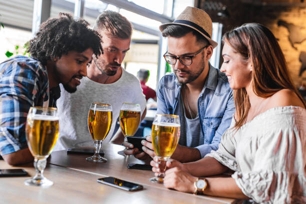 istock Group of friends drinking in a bar 1195087155