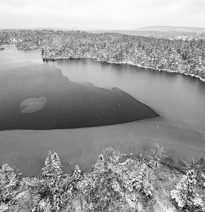 Aerial drone view of fresh snow and ice on a lake.