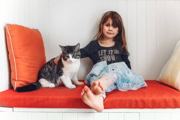Little Girl and Her Cat Looking Up.