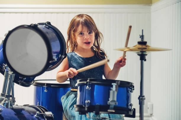 istock Little girl playing drum 1195088238