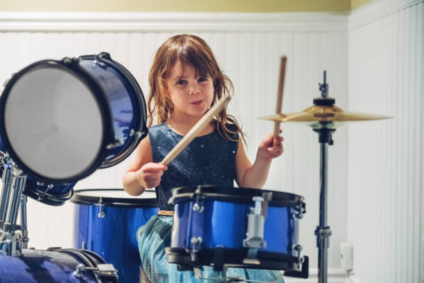 istock Little girl playing drum 1195088242