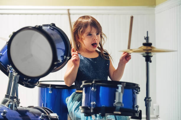 istock Little girl playing drum 1195088259