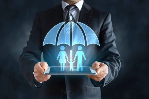 Photo of Family hologram under umbrella, insurance concept