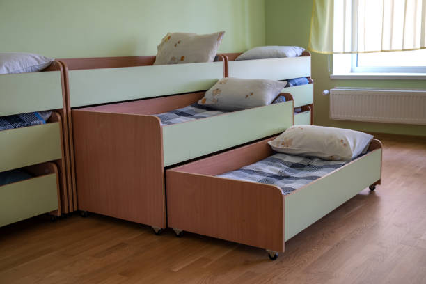 istock Many small beds in daycare preeschool empty bedroom. 1195090574