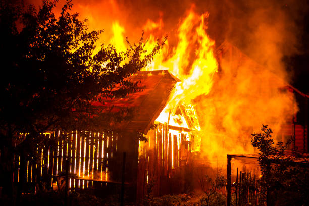 istock Wooden house or barn burning on fire at night. 1195090604
