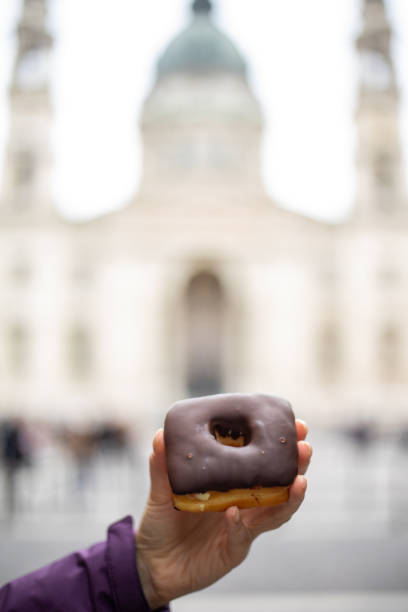 istock Woman holding donut 1195105197