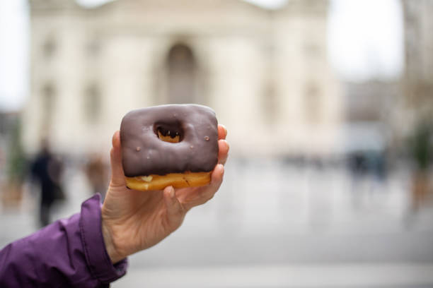 istock Woman holding donut 1195105218