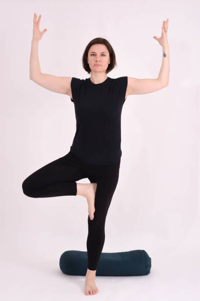 istock Yoga teacher performs asanas for her participants - Taking pictures in studio on white background 1195105900