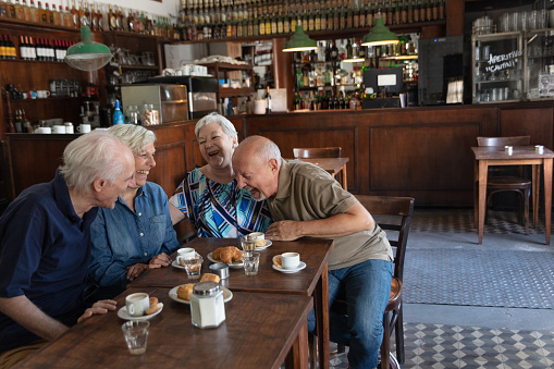 Portrait of group of seniors friends hangout in a typical bar of Buenos Aires