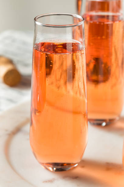Sparkling Red Rose Champagne Sparkling Red Rose Champagne in a Glass rose champagne stock pictures, royalty-free photos & images