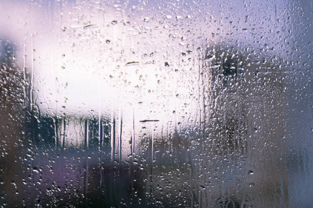istock Window glass with drops and shapes 1195112594