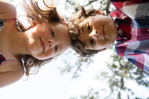 istock Boy and Girl Look Down at Camera 1195113217