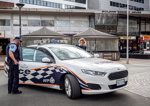 Canberra, Australia – Sep 3, 2018: An Australian Federal Police (AFP) car parked on the public area of the Canberra Center Shopping Mall. Officers entering vehicle on a routine surveillance exercise.
