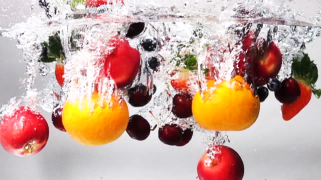 Super slow motion: Mix Fruit drop into fresh water on white background