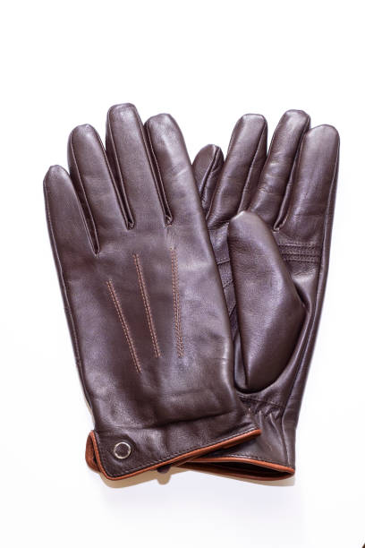 istock The warmed leather gloves, man's. Brown gloves on a white background, isolated object. 1195115408