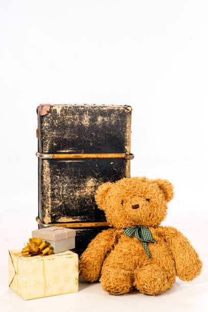 istock Teddy bear, presents and old suitcase on white background 1195115453
