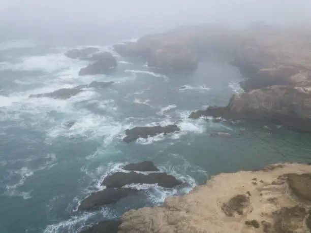 Photo of Aerial View of Rocky Shoreline and Fog in California